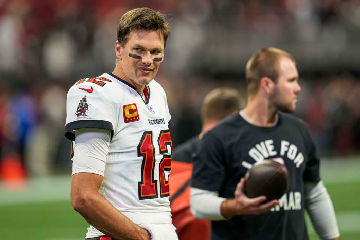 Tom Brady smiles during pre-game warmups before a Bucs-Falcons game in January